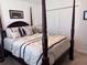 Cozy bedroom featuring a four-poster bed, plush pillows, and ample closet space at 3328 Davis Ter, The Villages, FL 32163