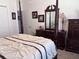 Well-appointed bedroom with a four-poster bed, dresser with mirror, and tasteful decor at 3328 Davis Ter, The Villages, FL 32163