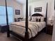 Elegant bedroom features a dark wood canopy bed with luxury bedding and stylish decor at 3328 Davis Ter, The Villages, FL 32163