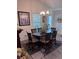Elegant dining room with a round wooden table and stylish chandelier at 3328 Davis Ter, The Villages, FL 32163