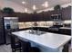 Modern kitchen features granite countertops, stainless steel appliances, and barstool seating at 3328 Davis Ter, The Villages, FL 32163