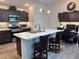 Modern kitchen with stainless steel appliances, island, barstool seating and adjacent office area at 3328 Davis Ter, The Villages, FL 32163