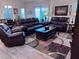 Comfortable living room features leather furniture, a coffee table, and a large window at 3328 Davis Ter, The Villages, FL 32163