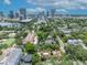 Expansive aerial view featuring a home with unique rooftop terraces amidst lush greenery and a vibrant city skyline at 337 Cathcart Ave # 6, Orlando, FL 32803