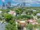 High angle showing a home with beautiful roof patios surrounded by lush landscapes and distant city skyline at 337 Cathcart Ave # 6, Orlando, FL 32803