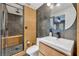 Modern bathroom features wood and grey tile, a glass shower door, and modern fixtures at 337 Cathcart Ave # 6, Orlando, FL 32803