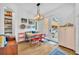 Bright dining area features a cozy banquette, red chairs, and stylish accents, with natural light from the adjacent doorway at 337 Cathcart Ave # 6, Orlando, FL 32803