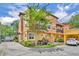Beautiful building exterior with a quaint balcony, stucco walls, a tile roof, and lush landscaping at 337 Cathcart Ave # 6, Orlando, FL 32803