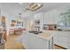 Bright kitchen featuring an island cooktop, white cabinetry, and a breakfast nook with a charming pendant light fixture at 337 Cathcart Ave # 6, Orlando, FL 32803