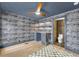 Office features a desk, built-in shelves, wood floor, patterned wallpaper, and en suite bathroom at 337 Cathcart Ave # 6, Orlando, FL 32803