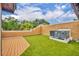 Rooftop patio with synthetic grass, orange stucco walls, and a composite deck at 337 Cathcart Ave # 6, Orlando, FL 32803