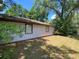 Grassy backyard offering ample space for outdoor activities, with mature trees providing natural shade at 3810 Se 22Nd Pl, Ocala, FL 34471