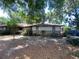 Charming single-story home with stone and siding exterior, nestled under mature trees offering shade at 3810 Se 22Nd Pl, Ocala, FL 34471