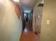 Hallway featuring wood floors and neutral walls that create a calming and inviting transition space at 3810 Se 22Nd Pl, Ocala, FL 34471