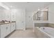 Elegant bathroom featuring double sinks, a soaking tub, and a separate shower at 4185 Paragraph Dr, Kissimmee, FL 34746