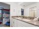 Double vanity bathroom with stone countertops, and access to another room at 4185 Paragraph Dr, Kissimmee, FL 34746