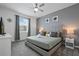 Comfortable bedroom features a soft bed, neutral tones and a window allowing natural light at 4185 Paragraph Dr, Kissimmee, FL 34746