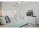 Comfortable bedroom features a soft bed, neutral tones, ceiling fan and adjoining bathroom at 4185 Paragraph Dr, Kissimmee, FL 34746