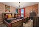 Themed bedroom with brick-style wall decor and two beds with themed bedding and curtains at 4185 Paragraph Dr, Kissimmee, FL 34746