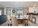 The dining room features a rustic wood table and cream-colored upholstered chairs under elegant lighting at 4185 Paragraph Dr, Kissimmee, FL 34746