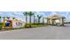 The Cove at Storey Lake entrance sign with a guard house in a tropical-themed neighborhood at 4185 Paragraph Dr, Kissimmee, FL 34746
