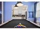 View of the kitchen from the game room featuring a pool table and a custom wall mural at 4185 Paragraph Dr, Kissimmee, FL 34746