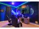 Fun game room featuring themed wallpaper, gaming chairs, and a wall-mounted television at 4185 Paragraph Dr, Kissimmee, FL 34746