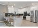 Modern kitchen with stainless steel appliances, a large island, and stylish bar seating at 4185 Paragraph Dr, Kissimmee, FL 34746