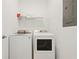 Laundry room with washer, dryer, and storage shelves at 4185 Paragraph Dr, Kissimmee, FL 34746