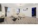 Open living room with white sectional sofa, modern lighting, and neutral carpet at 4185 Paragraph Dr, Kissimmee, FL 34746