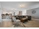 Open concept living and dining area, featuring tile floors, neutral paint, and a leather sofa at 4185 Paragraph Dr, Kissimmee, FL 34746