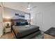 Comfortable bedroom with a gray bed, blue accents, and a ceiling fan at 4185 Paragraph Dr, Kissimmee, FL 34746