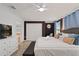 Well-lit bedroom featuring a king-size bed, ensuite bathroom, and plenty of storage at 4185 Paragraph Dr, Kissimmee, FL 34746