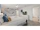 Bright main bedroom showcasing modern decor, a king-size bed, and ensuite bathroom access at 4185 Paragraph Dr, Kissimmee, FL 34746