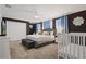 Spacious bedroom with a king-size bed, ample closet space, and a crib at 4185 Paragraph Dr, Kissimmee, FL 34746