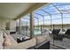 Enclosed pool area with comfortable lounge seating and a view of a peaceful pond at 4185 Paragraph Dr, Kissimmee, FL 34746
