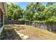 A backyard with a wooden fence for privacy, grass, stepping stones, and mature trees at 4447 Brook Hollow Cir, Winter Springs, FL 32708
