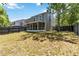An expansive backyard with a well-maintained lawn, a fence, and a screened porch for outdoor enjoyment at 4447 Brook Hollow Cir, Winter Springs, FL 32708