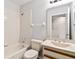 A bathroom with a vanity, mirror, toilet, and a tiled shower-tub combo, providing essential amenities at 4447 Brook Hollow Cir, Winter Springs, FL 32708