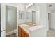 Bathroom with a wood vanity, granite countertop, single sink, and walk-in shower with beige tile at 4447 Brook Hollow Cir, Winter Springs, FL 32708