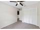A cozy bedroom featuring neutral paint, a ceiling fan, carpet, and closet with louvered doors at 4447 Brook Hollow Cir, Winter Springs, FL 32708