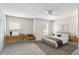 Staged bedroom featuring neutral walls, carpeted floors, a ceiling fan, and natural lighting at 4447 Brook Hollow Cir, Winter Springs, FL 32708
