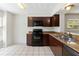 Well-lit kitchen with tile flooring, stainless steel appliances, and dark wood cabinets at 4447 Brook Hollow Cir, Winter Springs, FL 32708