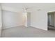 Living room with neutral paint, carpeted floors, a ceiling fan, and views into other rooms at 4447 Brook Hollow Cir, Winter Springs, FL 32708