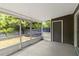 A screened porch providing pest-free outdoor enjoyment with a door leading to the home's interior at 4447 Brook Hollow Cir, Winter Springs, FL 32708