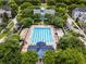 Aerial view of a swimming pool and clubhouse, surrounded by trees and lounge chairs at 4562 Lower Park Rd, Orlando, FL 32814
