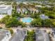 Aerial view of community pool surrounded by lush trees and townhomes, offering a tranquil retreat at 4562 Lower Park Rd, Orlando, FL 32814