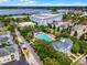 Aerial view of the community featuring a sparkling pool, lake views, and beautiful architecture at 4562 Lower Park Rd, Orlando, FL 32814