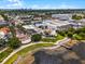 Aerial view showcases a picturesque community with tree-lined streets, and a nearby lake at 4562 Lower Park Rd, Orlando, FL 32814