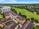 Scenic aerial view of tan condos with terracotta roofs overlooking a lush green field and tree-lined streets at 4562 Lower Park Rd, Orlando, FL 32814